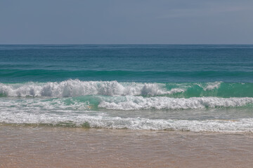 Beautiful beach on a summer day. Blue sky. Sunny day. Yellow sand on the beach.