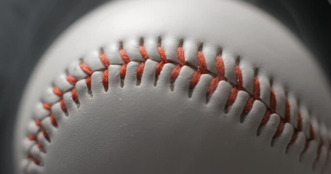 Baseball ball close up rotating in studio with smoke in slow motion