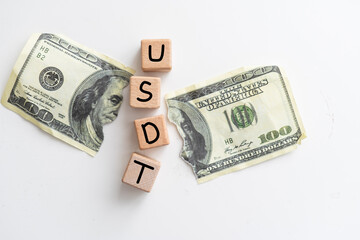 Wooden cubes with USD and up-down arrows over 100 usd.