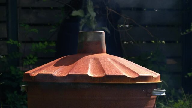 Garden and house garbage burning in a bin incinerator
