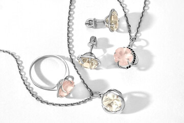 Elegant jewelry set. Jewellery set with gemstones. Jewelry accessories collage. Product still life concept. Ring, necklace and earrings.