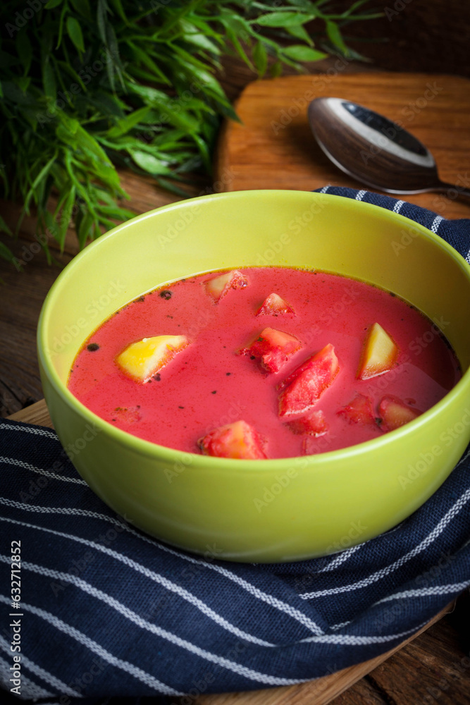 Poster vegetarian red soup - borsch in green bowl.