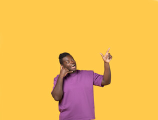 Happy African Man Holding Hand Near Ear Pointing Up, Studio