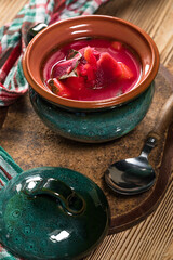 Red borscht soup in bowl.