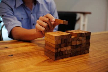 Planning risk and strategy in businessman gambling placing wooden block.Business concept for growth...