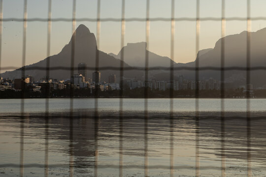 Rodrigo de Freitas lagoon  (Lagoa Rodrigo de Freitas) seen from behind the bars during sunset in Rio de Janeiro.