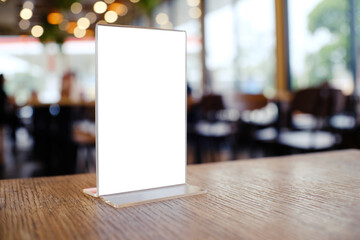 Mock up Menu frame standing on wood table in Bar restaurant cafe. space for text