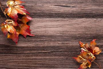 Naklejka na ściany i meble autumn concept with hammered copper leaves on a wooden background
