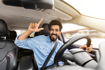 Happy indian man driver going vacation by car