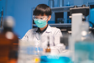 woman scientist working at laboratory overtime late at night looking to side, confident research...