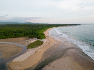 beautiful Sunset with green nature and blue ocean  From The Tamarindo Beach In Guanacaste In Costa Rica Drone Video top view Sunset 