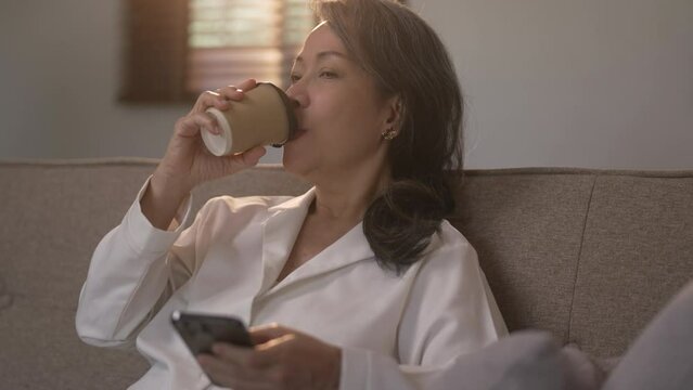 Relaxed senior woman using smartphone for online social media.