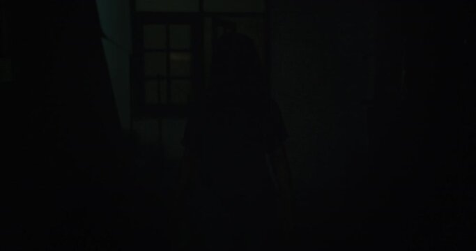 Horror scene of a mysterious Scary Asian ghost woman creepy have hair covering the face walking to camera at abandoned house with dark scene movie at night, festival Halloween concept