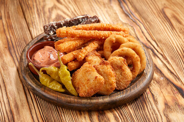 tasty snacks on the wooden background