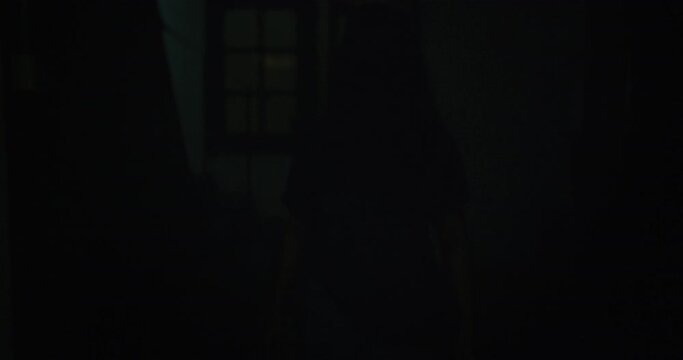 Horror scene of a mysterious Scary Asian ghost woman creepy have hair covering the face walking to camera at abandoned house with dark scene movie at night, festival Halloween concept