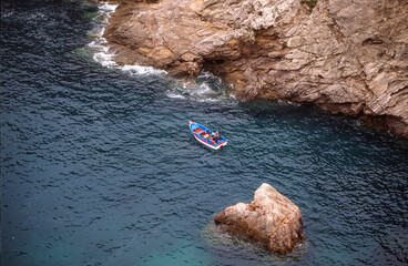 Fishing boat near the rocky coast of Sagres. Algarve, Portugal, Europe