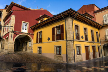 Beautiful street in the old town of the beautiful city of Aviles with its historic buildings with arcades in a sunny day, Asturias, Spain.