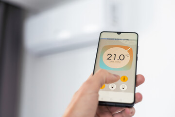 Close up focus on cellphone with smart home software application on screen, wireless light music temperature regulation with digital gadget, air conditioner climate control, iot, virtual assistant