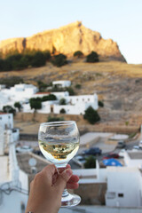 Glass of wine and Greek white houses