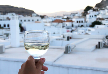 Glass of wine and Greek white houses