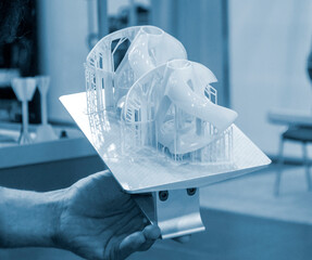 Printed models on 3D printer close-up. Objects printed on photopolymer sla 3D printer from liquid photopolymer resins on printing platform. Modern progressive additive technology. 3D printer printing