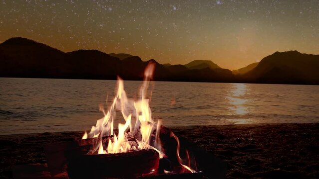 a bonfire burns at night against the background of mountains and sea with bright stars