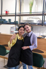 Cute female colleagues at the working place at the cafe