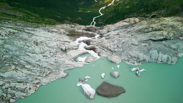 
A lake formed as a result of the melting of a glacier in Rhonegletscher Switzerland, water from the glacier enters the lake after a large stream falls from a cliff