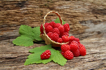 japanese grape berries in a rustic basket and wooden background