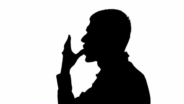 Black silhouette of a man licking his fingers on his hands. black and white mask