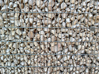 Fence made of stones in a grid (gabion) for the house
