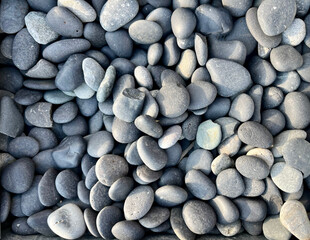 The background is made of large pebbles of gray color. The texture is made of gray pebbles. Pebbles for garden paths