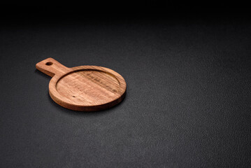 Empty round kitchen wooden cutting board in brown color