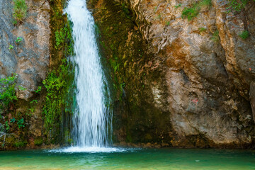Fototapeta na wymiar waterfall in the mountains, beautiful summer bright landscape