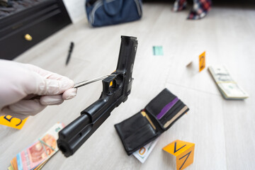 Detective in gloves looking evidence, crime scene