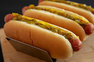 Homemade Gourmet Hot Dogs with Sweet Relish and Mustard, side view. Close-up.