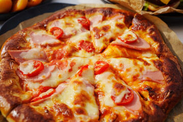 close-up. Pizza with ham, cheese and tomatoes. 