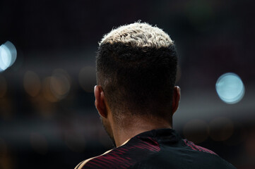 the back of the football player's head with his hair painted white