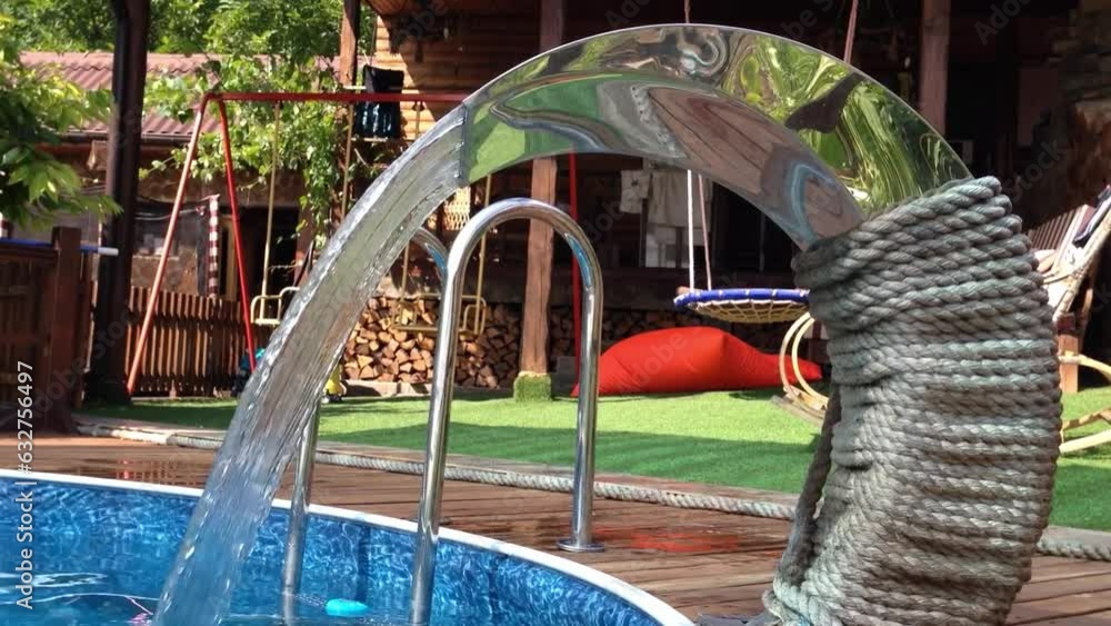 Poster video on process of turning on artificial waterfall in pool in summer