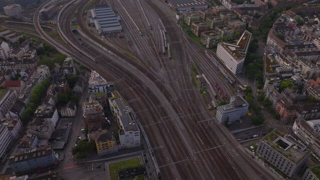 High angle view of extensive railroad yard with tracks and switches. Trains arriving from different directions. Zurich, Switzerland