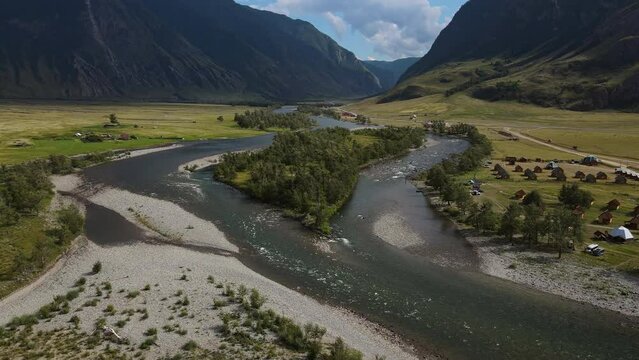 Aerial view of the beautiful valley and river surrounded by high mountain ranges