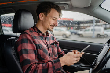 one adult man caucasian with mustaches sit in car use mobile phone
