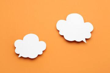 Empty speech bubbles on orange background