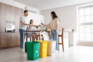 Family sorting garbage with recycle bins in kitchen