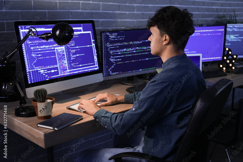Aufkleber male programmer working with computer in office at night