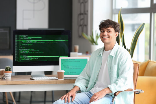 Male programmer sitting in office