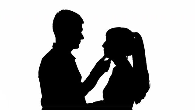 Silhouette of a kissing couple of a man with a woman. black and white mask