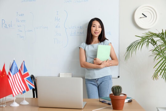 Female English teacher giving online grammar lesson in classroom