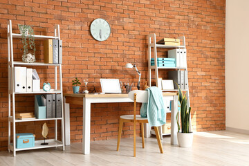 Interior of office with workplace and shelving units