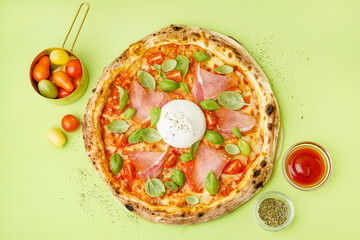 Tasty pizza with Burrata cheese on green background